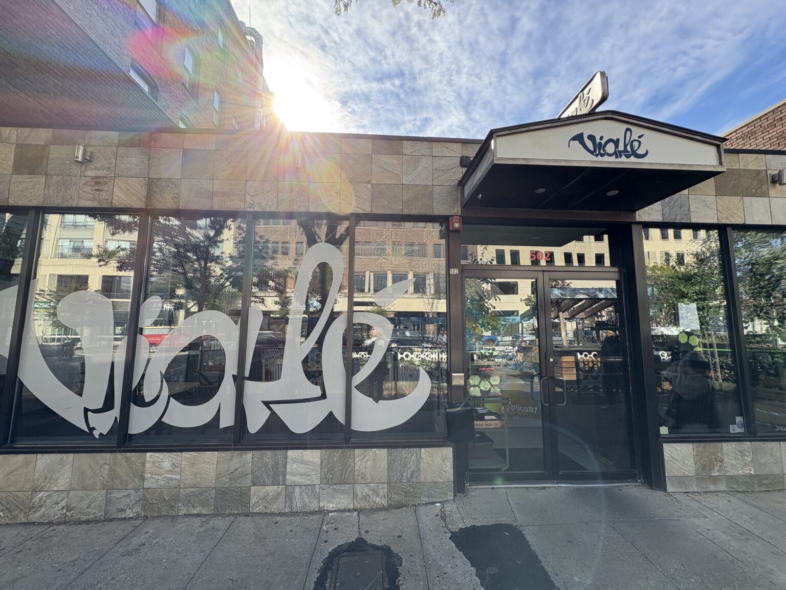 Outside of Viale. Viale is written in white graffiti style on the windows.