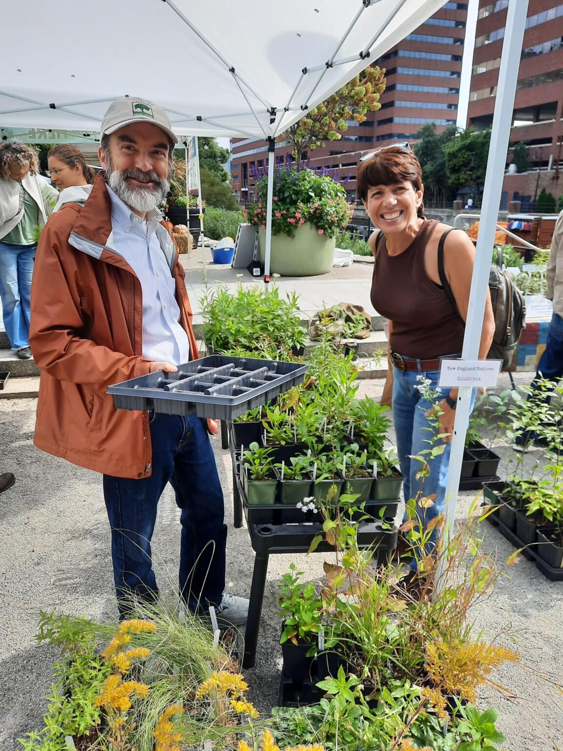 People showing off plants at Kendall Square Farmers Market.