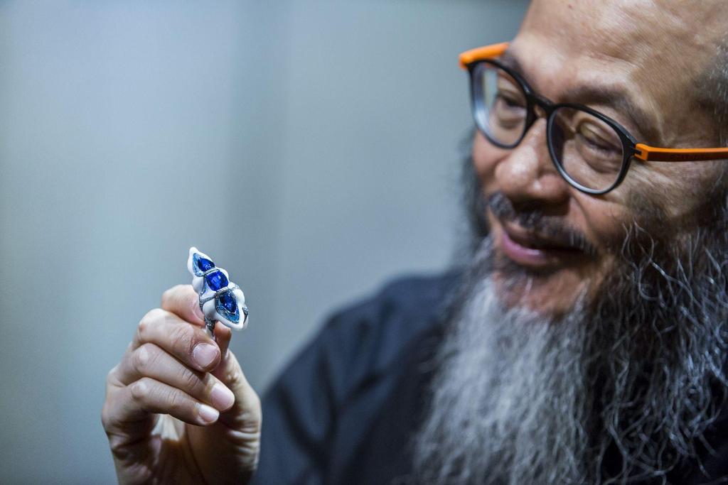 A man holding a piece of art.