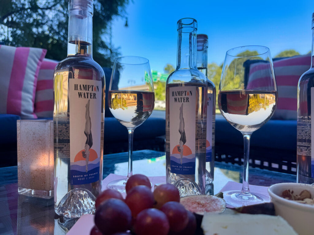 Wine and grapes with a city backdrop