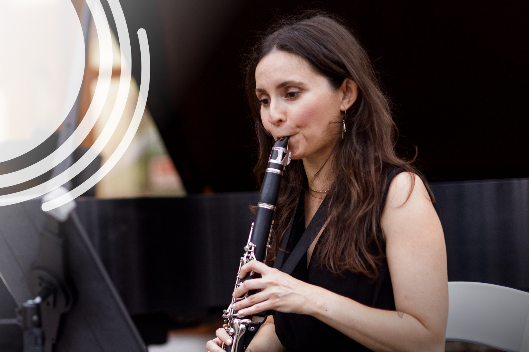 A woman playing the clarinet.