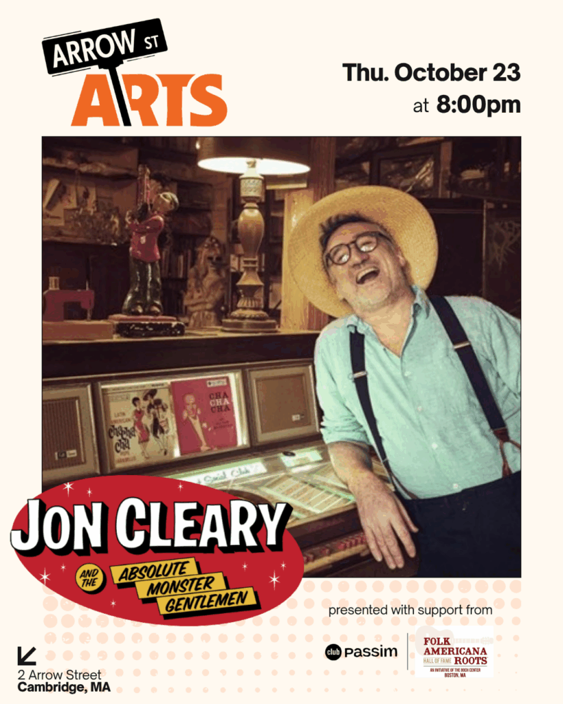 Jon Cleary laughing and leaning against records.